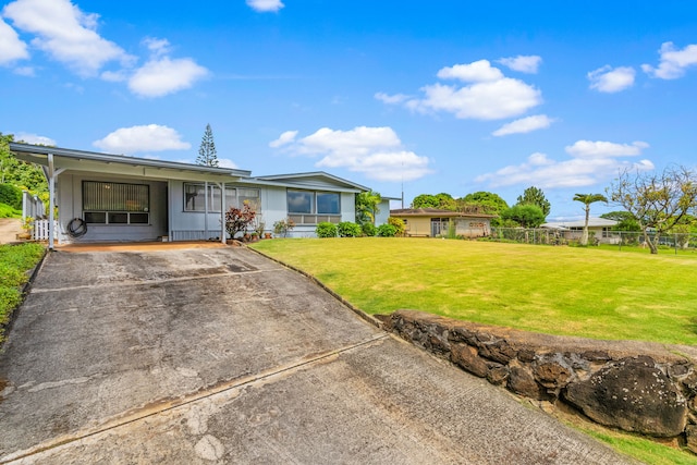 view of front of property with a front yard and a carport