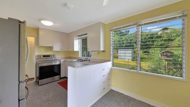 kitchen with white cabinets, plenty of natural light, sink, and appliances with stainless steel finishes