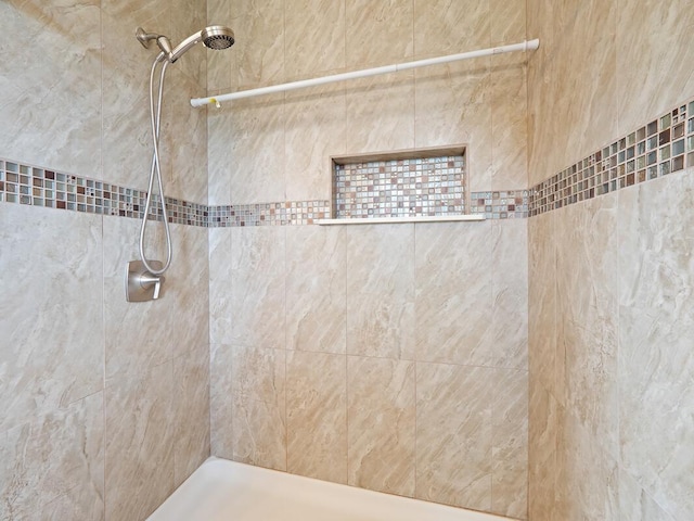 bathroom with tiled shower