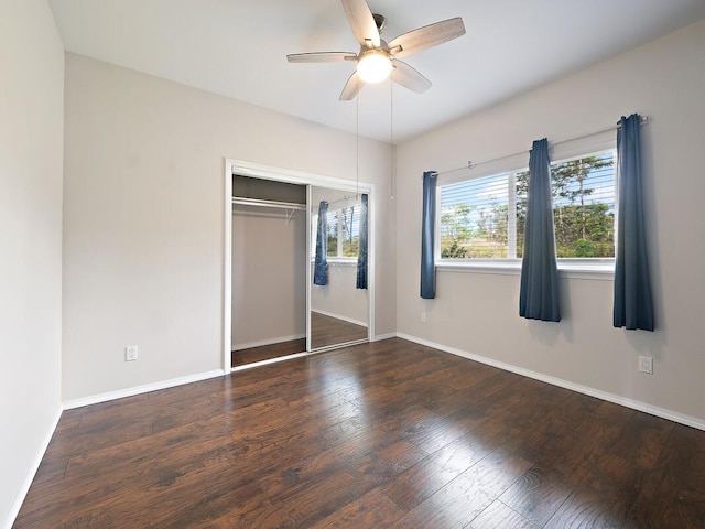 unfurnished bedroom featuring ceiling fan, dark hardwood / wood-style floors, and a closet