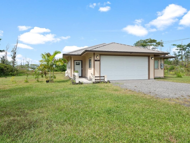 view of front of home with a front yard and a garage