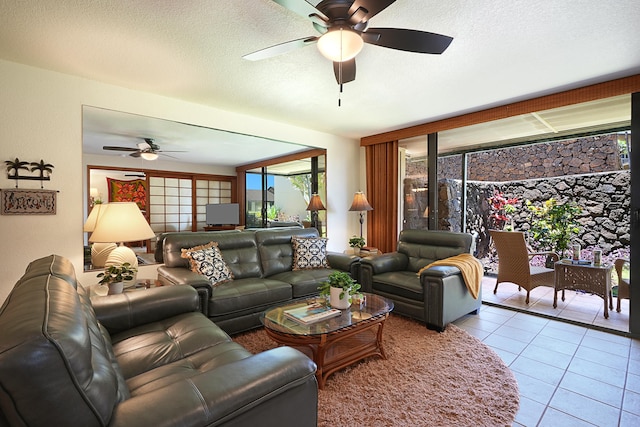 tiled living room featuring a textured ceiling and ceiling fan