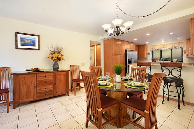 dining space featuring a notable chandelier and light tile patterned floors