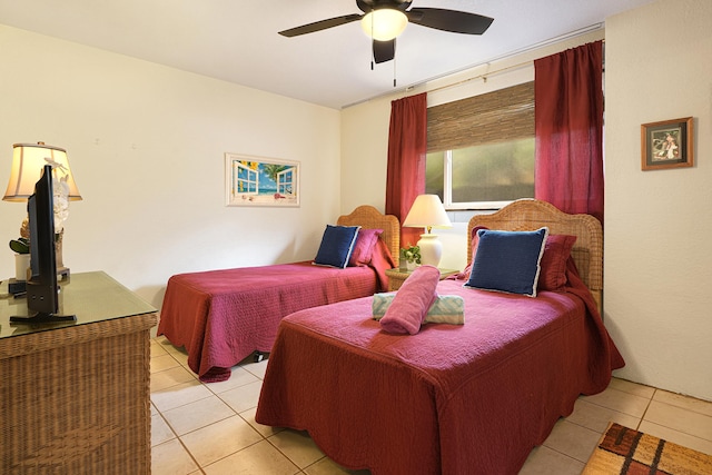 bedroom with ceiling fan and light tile patterned floors