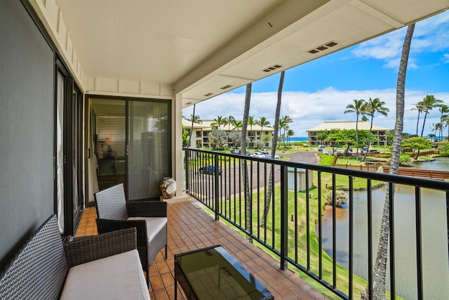 balcony featuring a water view