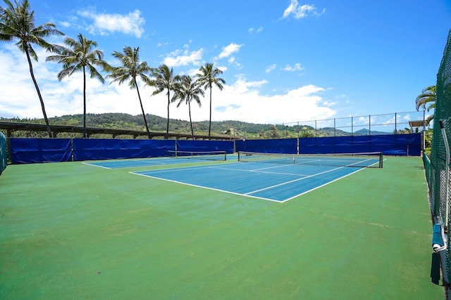 view of tennis court featuring basketball hoop