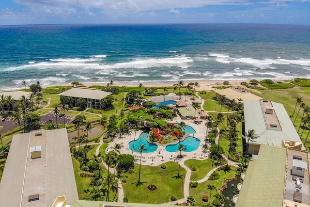 birds eye view of property featuring a water view and a beach view