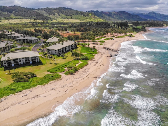 drone / aerial view featuring a view of the beach and a water and mountain view