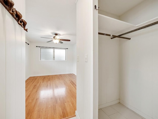 spacious closet with hardwood / wood-style floors and ceiling fan