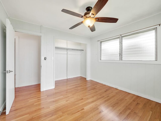 unfurnished bedroom featuring a closet, light hardwood / wood-style floors, and ceiling fan