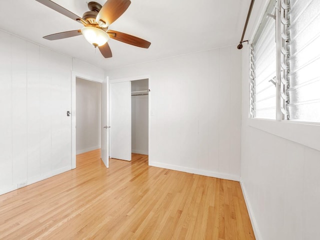 unfurnished bedroom featuring wood-type flooring, a closet, and ceiling fan