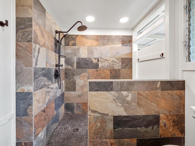 bathroom with a tile shower