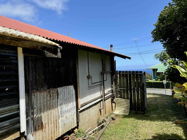 view of side of property with a lawn