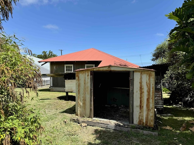 view of outbuilding with a yard