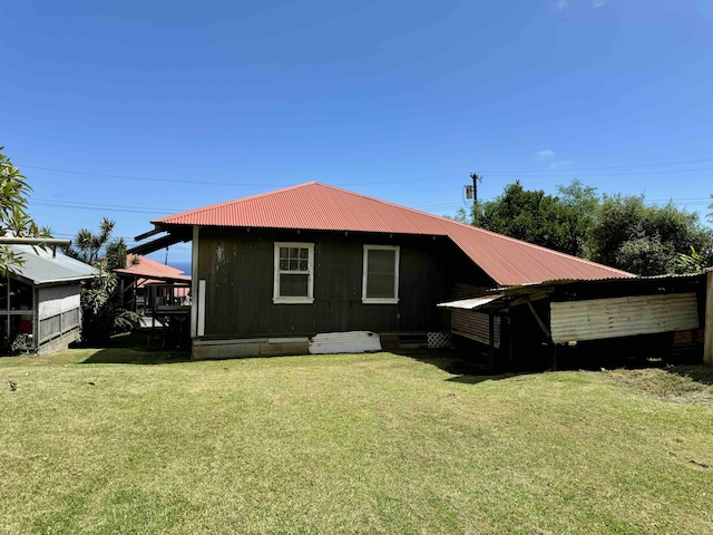 back of property featuring a lawn