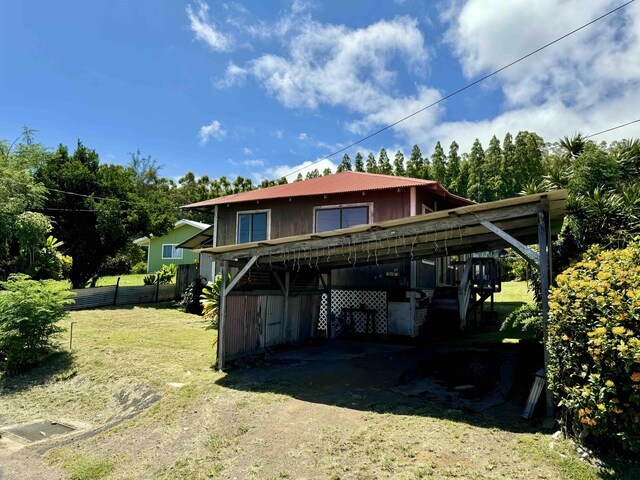 rear view of house with a yard