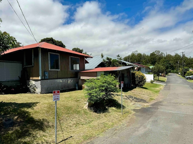 view of side of home featuring a yard