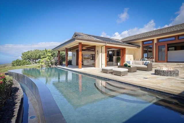 view of pool with an outdoor living space and a patio