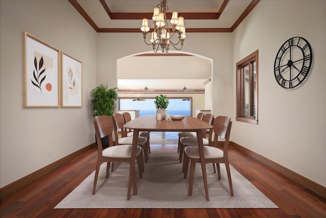 dining area with dark hardwood / wood-style flooring, ornamental molding, and a chandelier