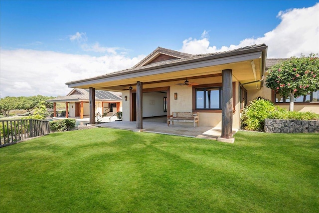 back of house featuring a lawn, a patio area, and ceiling fan