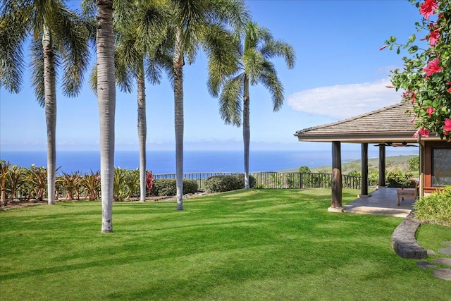 view of yard with a water view and a patio