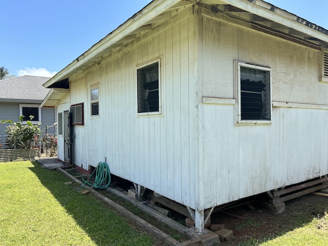 view of side of home featuring a lawn