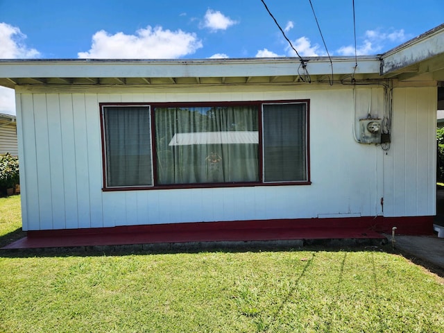 view of side of home featuring a lawn