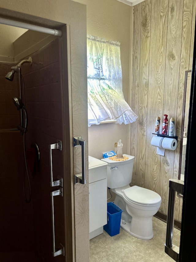 bathroom with toilet, walk in shower, and wood walls