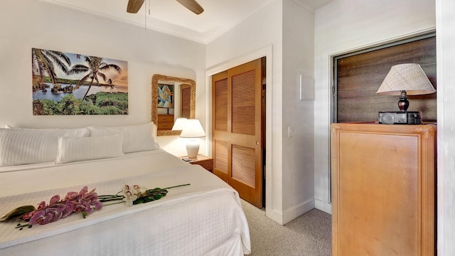 carpeted bedroom featuring a closet, ceiling fan, and ornamental molding