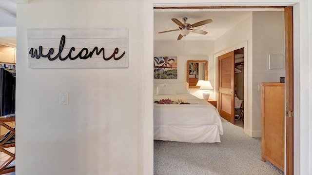 carpeted bedroom featuring a closet and ceiling fan