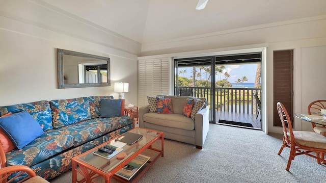 carpeted living room with a water view and lofted ceiling