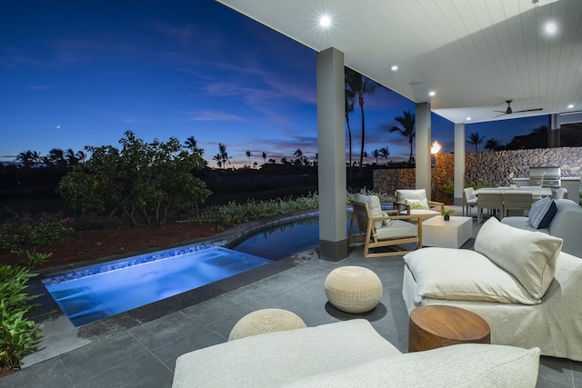 patio terrace at dusk featuring a fenced in pool and ceiling fan