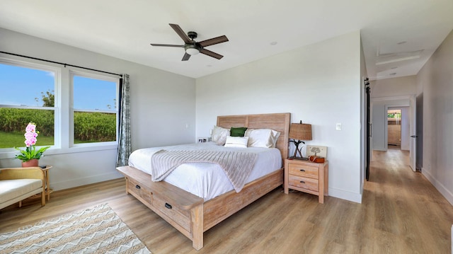 bedroom with ceiling fan and hardwood / wood-style floors