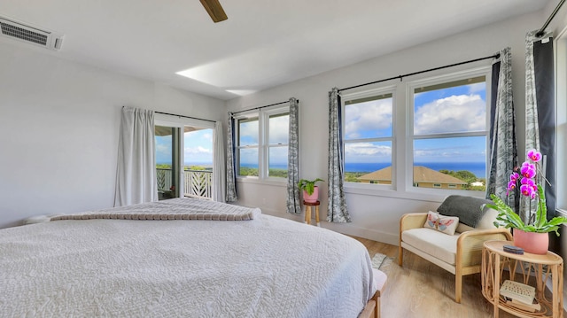 bedroom featuring hardwood / wood-style flooring, ceiling fan, and access to exterior