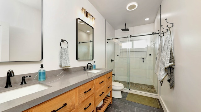 bathroom featuring dual vanity, tile flooring, an enclosed shower, and toilet