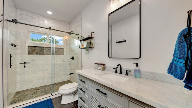 bathroom with tile flooring, an enclosed shower, toilet, and large vanity