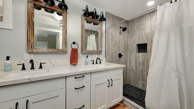 bathroom with a shower with curtain and dual bowl vanity