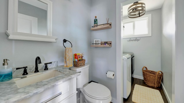 bathroom with hardwood / wood-style flooring, toilet, and large vanity