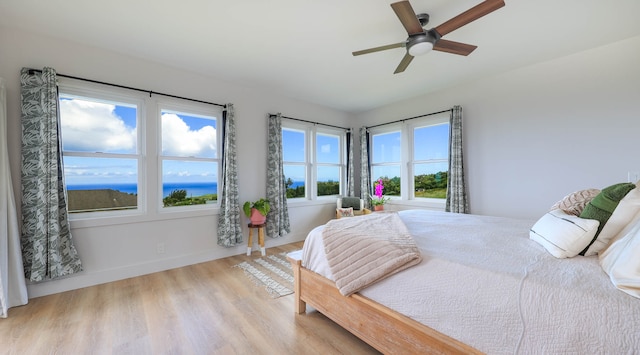 bedroom with ceiling fan and light wood-type flooring