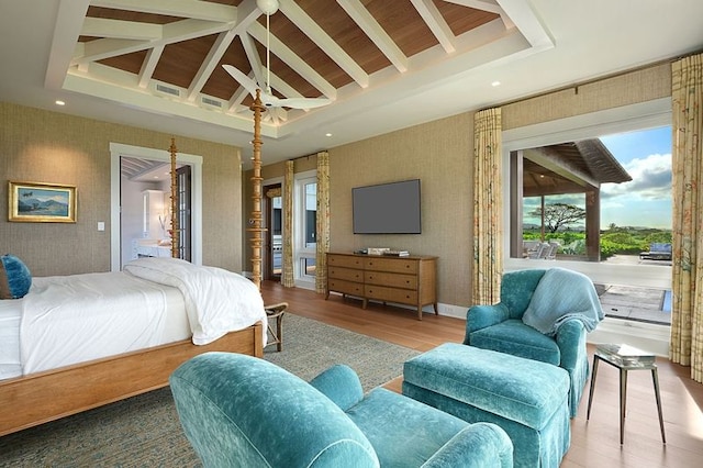 bedroom featuring vaulted ceiling with beams and hardwood / wood-style floors