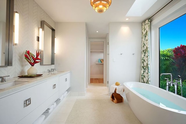 bathroom with plenty of natural light, tile patterned flooring, and double sink vanity