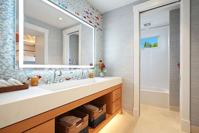 bathroom with vanity, backsplash, tile walls, and tile patterned floors