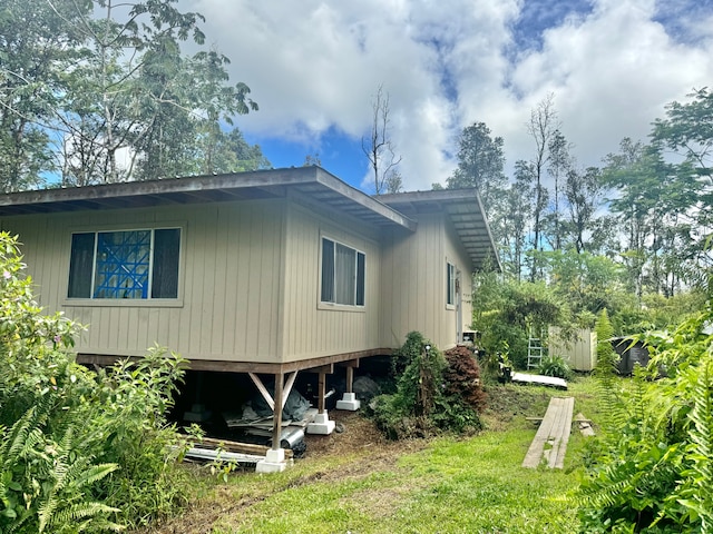 view of property exterior featuring a lawn