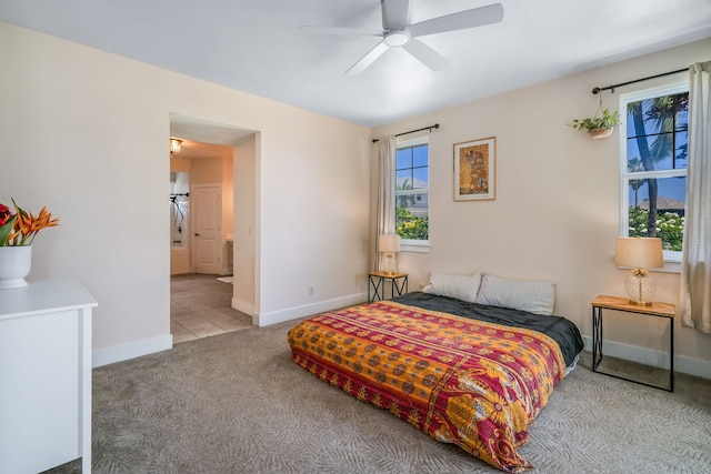 carpeted bedroom with connected bathroom and ceiling fan