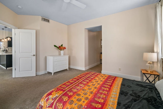 carpeted bedroom featuring ceiling fan and sink