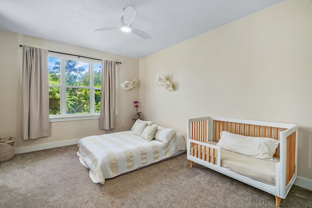 bedroom featuring ceiling fan and carpet