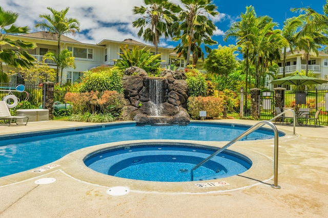 view of swimming pool featuring a community hot tub