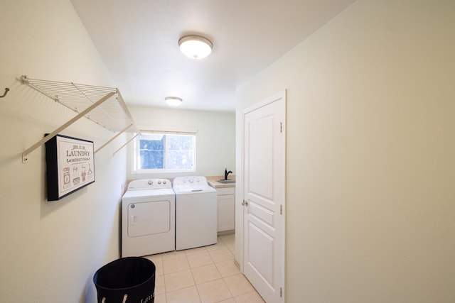 washroom with washing machine and dryer, sink, light tile patterned floors, and cabinets