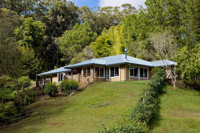 rear view of house featuring a yard