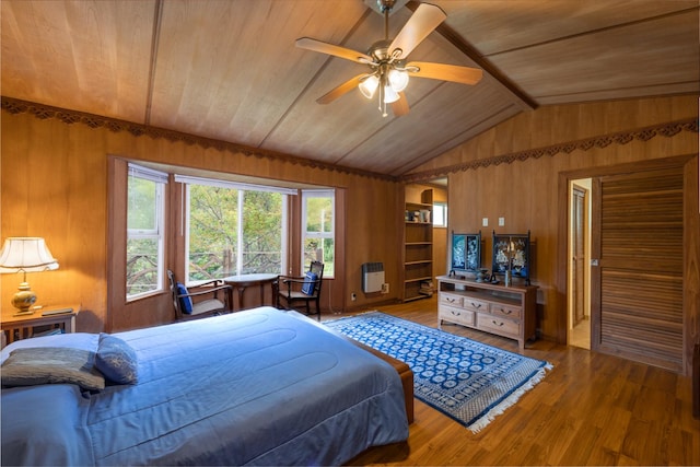 bedroom featuring heating unit, vaulted ceiling, ceiling fan, wood-type flooring, and wooden ceiling